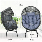 Grey-blue cushioned egg chair with dark rattan frame and four splayed legs