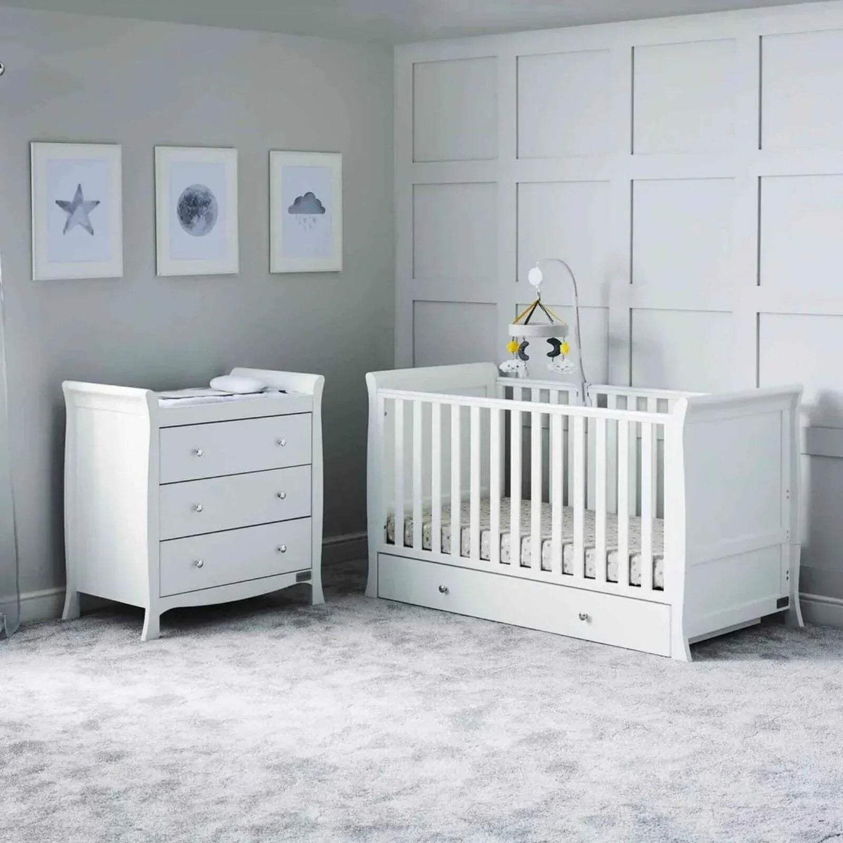 White nursery cot with matching dresser and vertical rail side