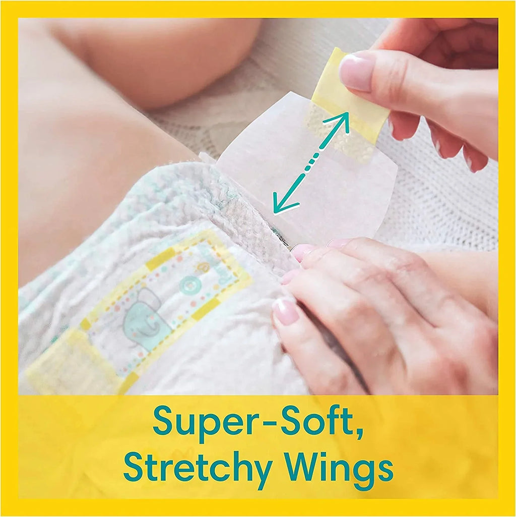 Newborn diaper with adjustable stretchy wings and adhesive tabs