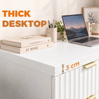 White desk with thick tabletop and ribbed cabinet front, gold bar handle