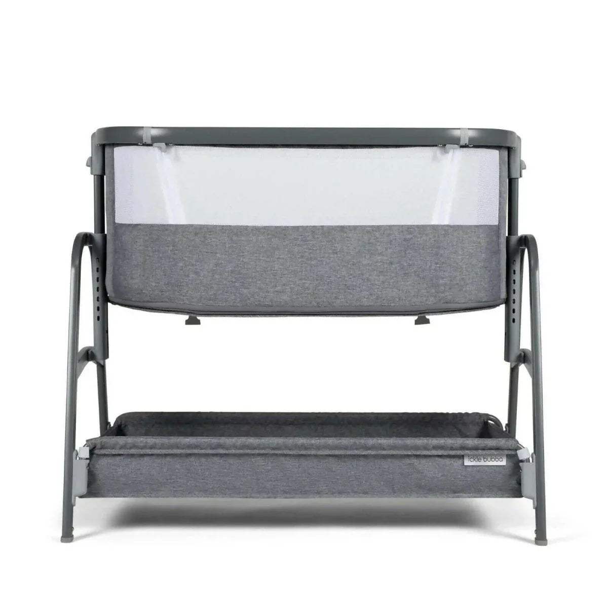 Grey bedside crib front view with fabric wall panel and padded base insert, open top.