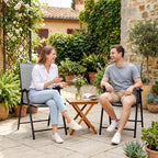 Pair of light gray high-back folding patio chairs with armrests