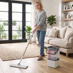 Woman using compact flat mop with gray pad and white bucket during floor cleaning