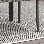 Outdoor chair seat and legs in dark frame with grey woven texture
