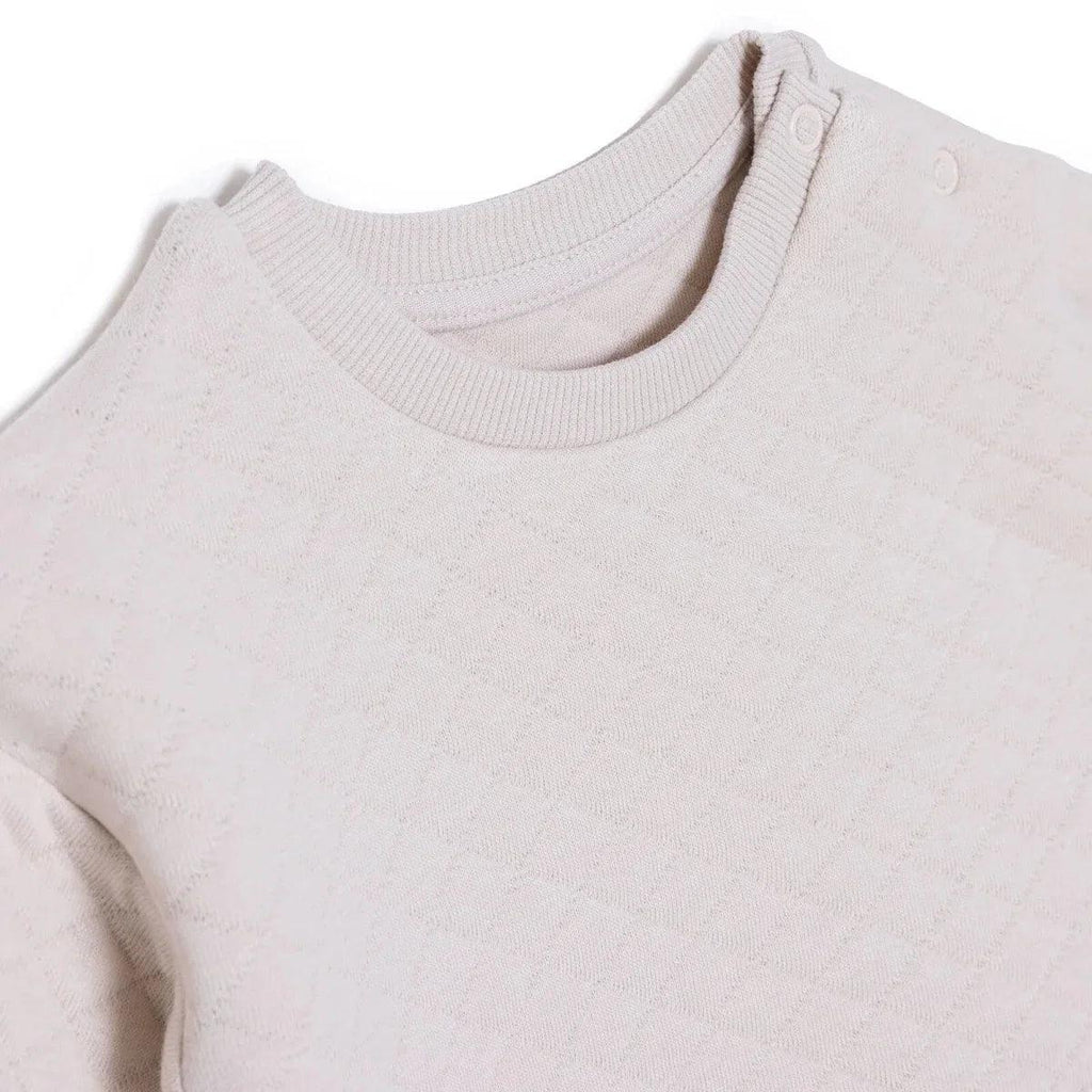 Beige quilted baby sweatshirt with crew neck and ribbed collar detail