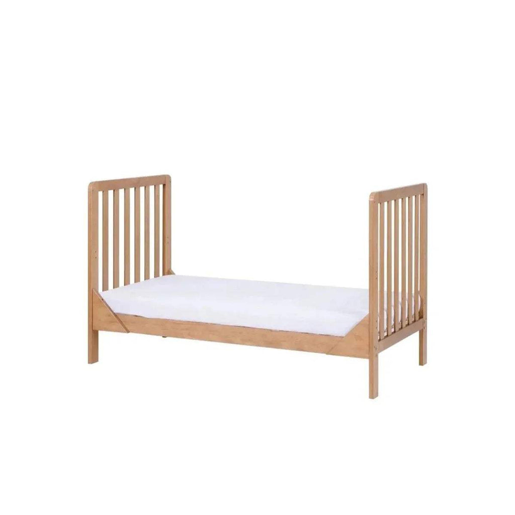 Honey oak cot bed with slatted sides and light mattress