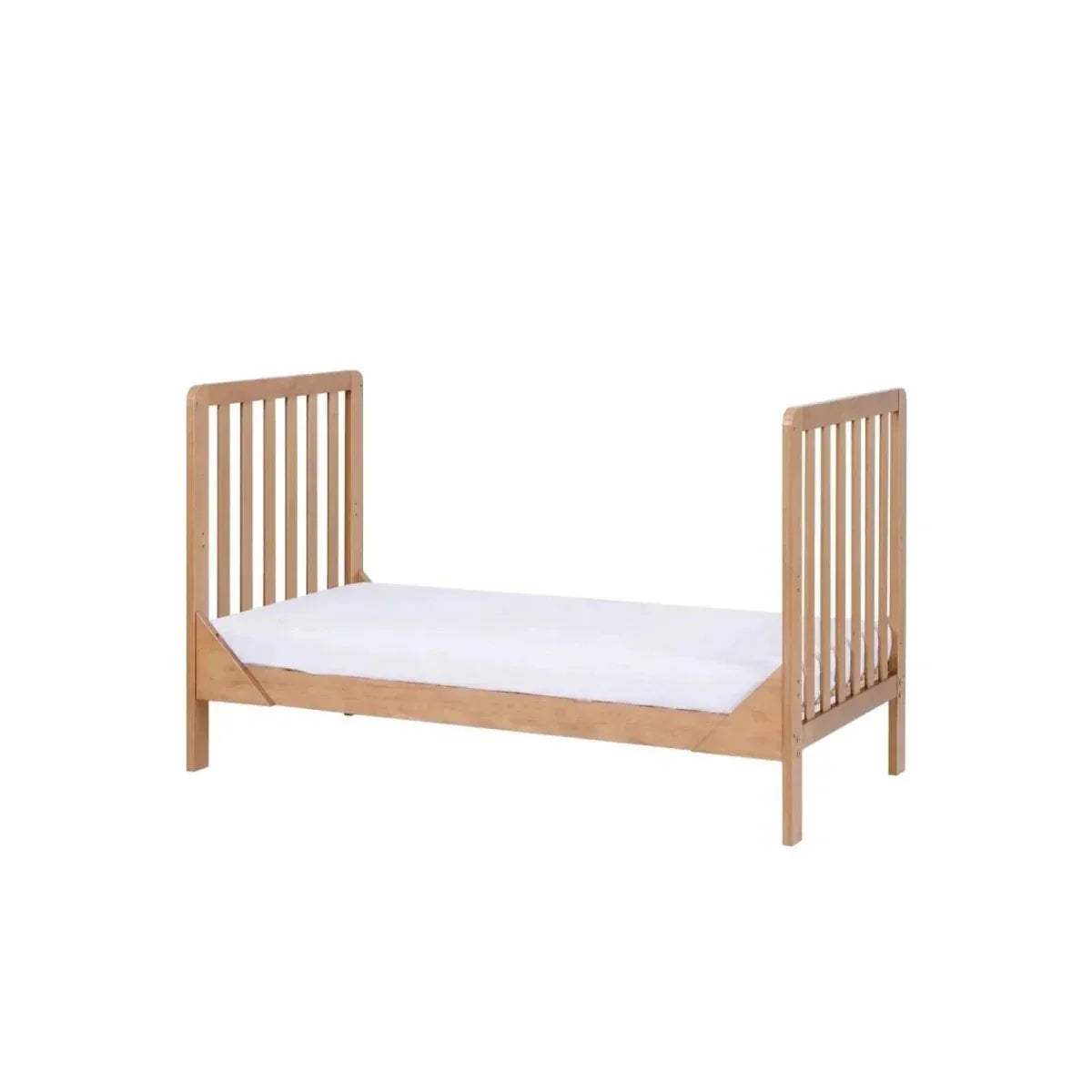 Honey oak cot bed with slatted sides and light mattress