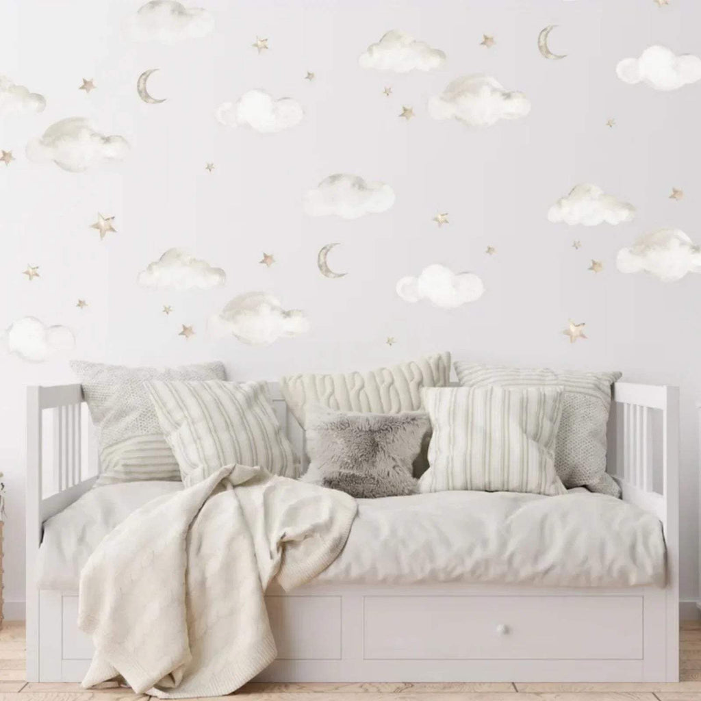 Cloud, moon & star wall stickers above white bed and pillows