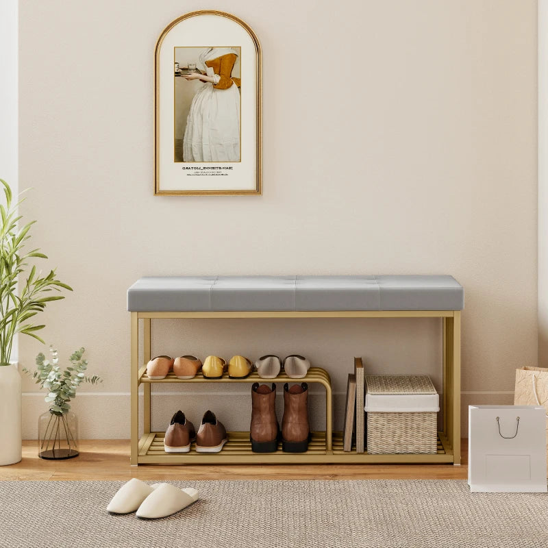 Grey tufted shoe storage bench with open gold-toned steel shelves and shoe display