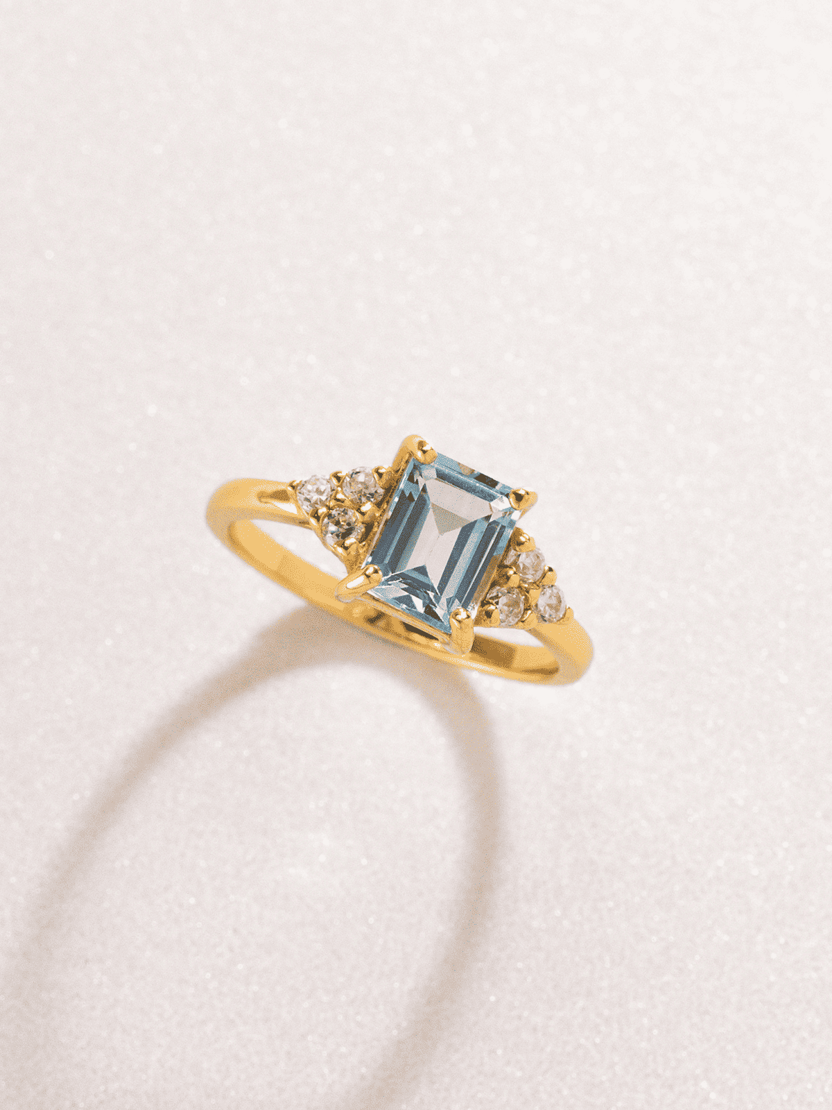Gold vermeil emerald-cut blue topaz ring with clustered round sparkle accents
