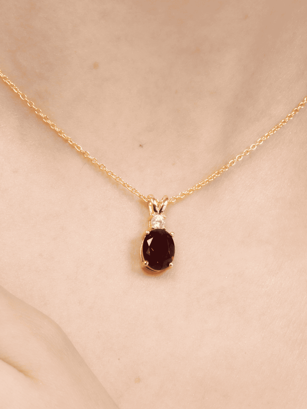 Gold-toned garnet oval pendant necklace with prong-set sparkle stones