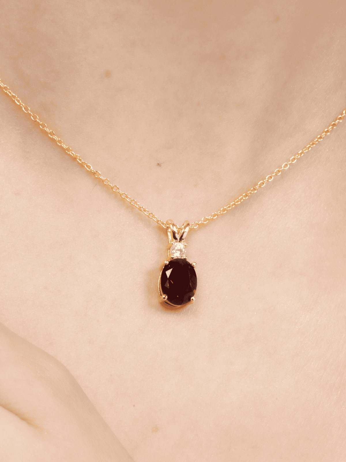 Gold-toned garnet oval pendant necklace with prong-set sparkle stones