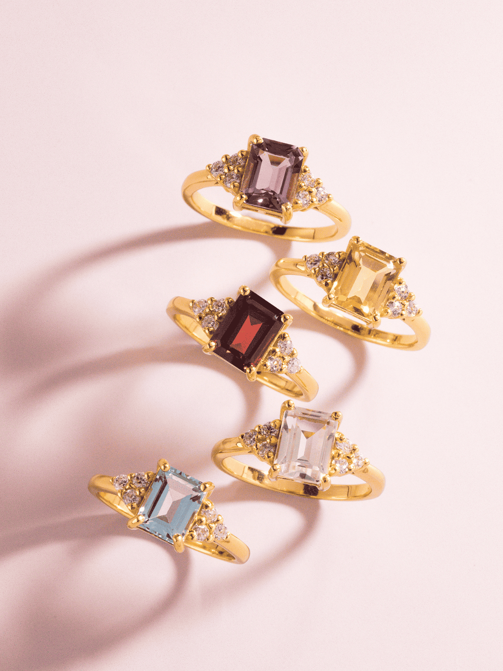 Gold vermeil ring set with emerald-cut stones and small round clear accents