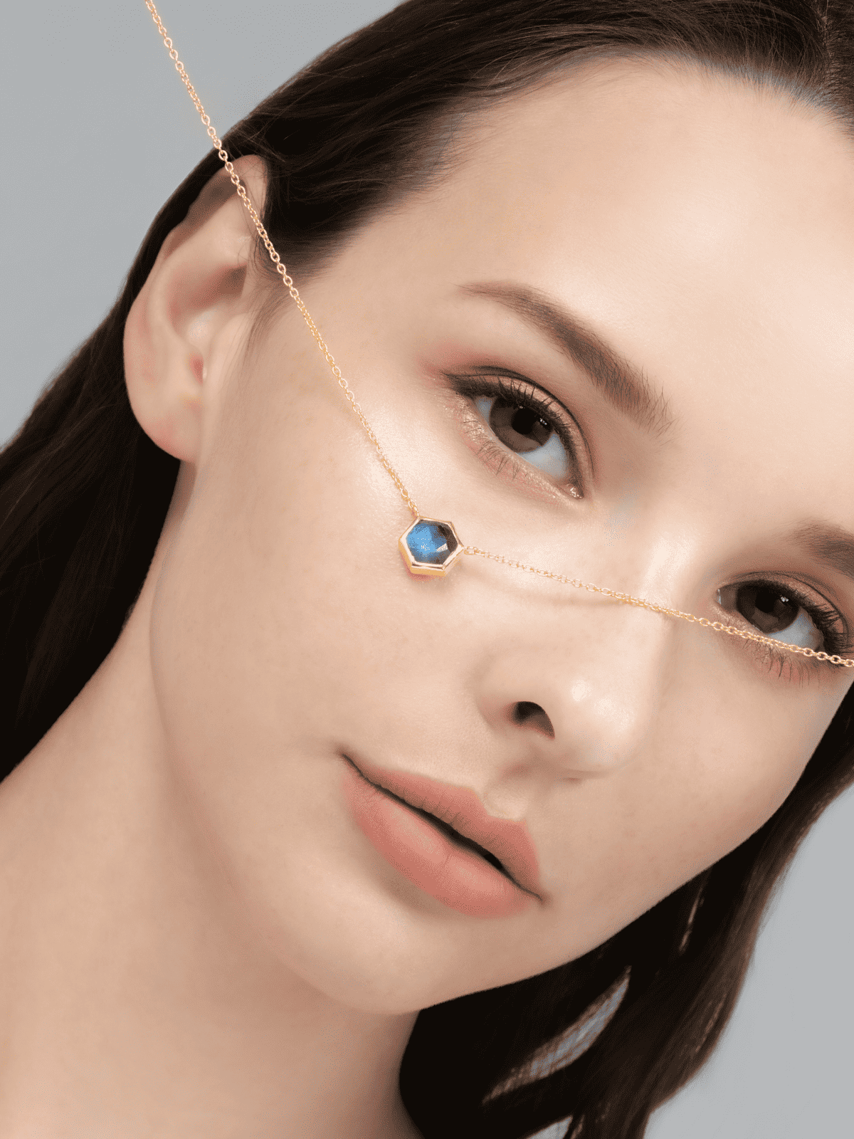 Gold vermeil labradorite necklace featuring a faceted blue hex pendant on chain