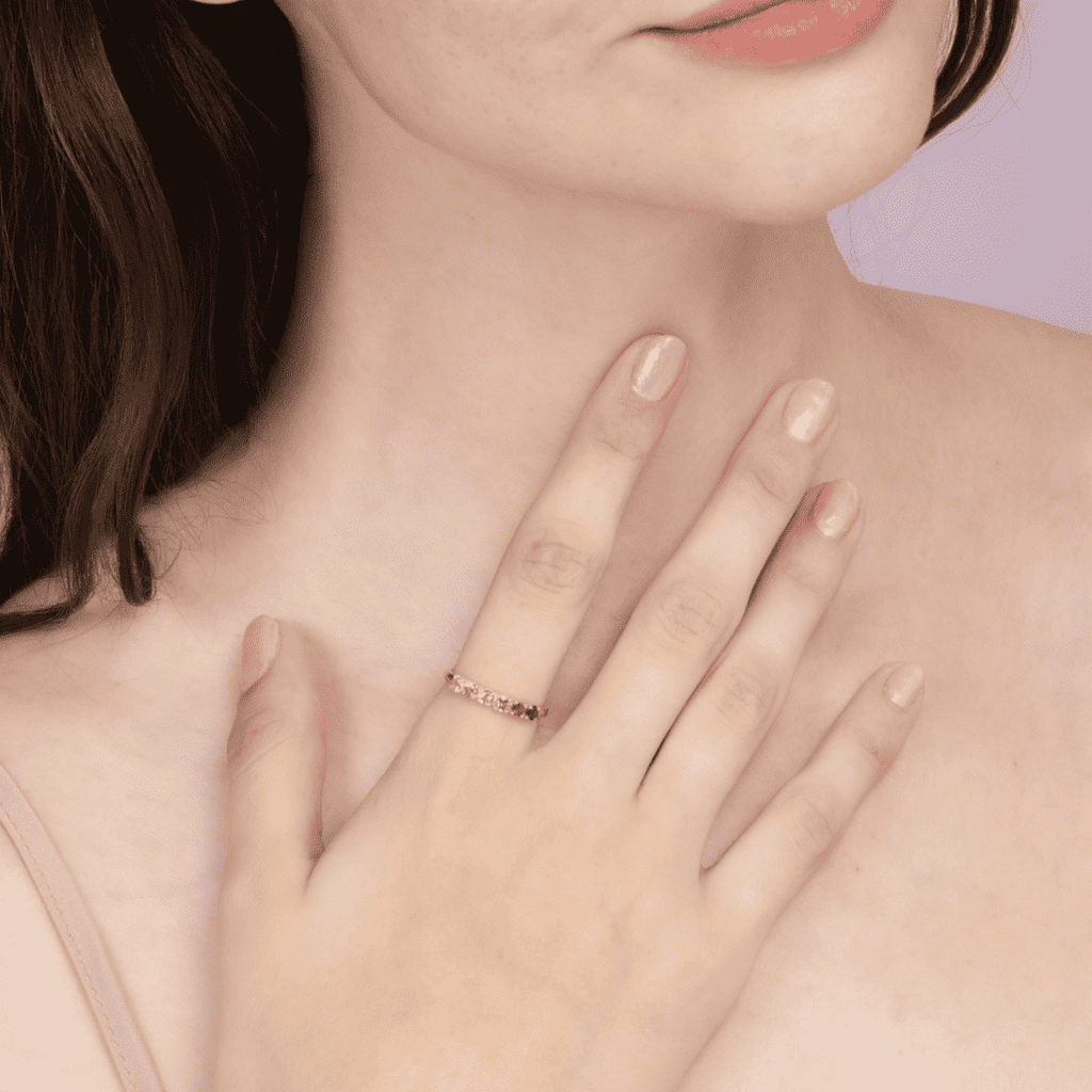 Pink tourmaline eternity ring with thin gold band on hand