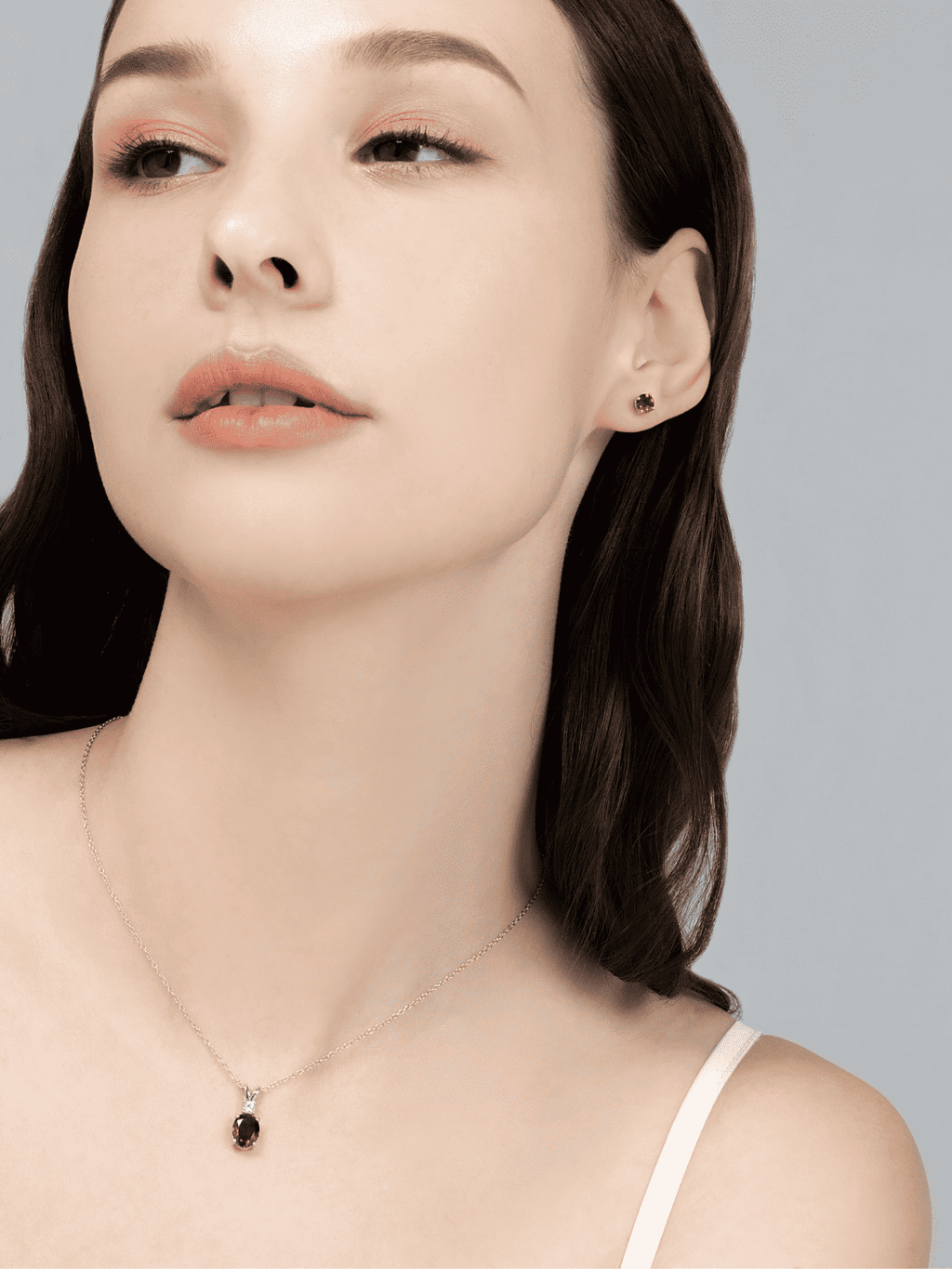 Sterling silver chain necklace with a small round garnet pendant