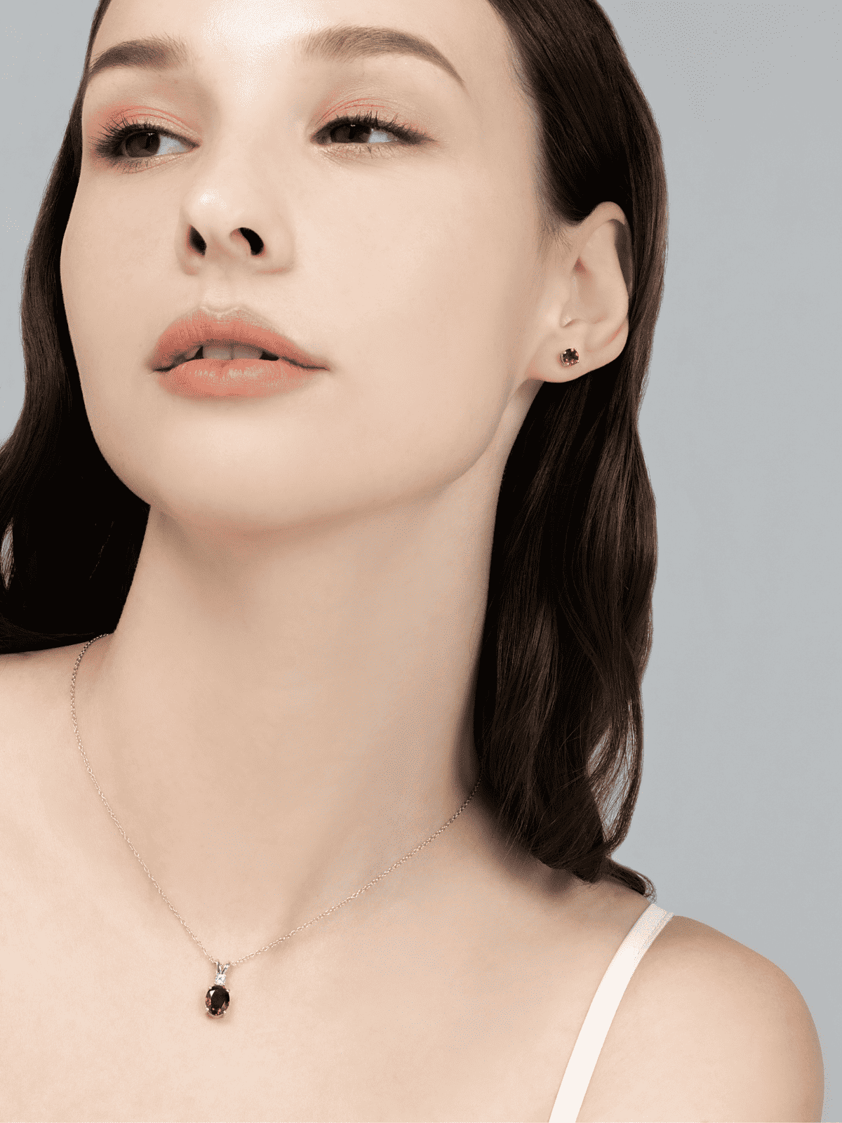 Sterling silver chain necklace with a small round garnet pendant