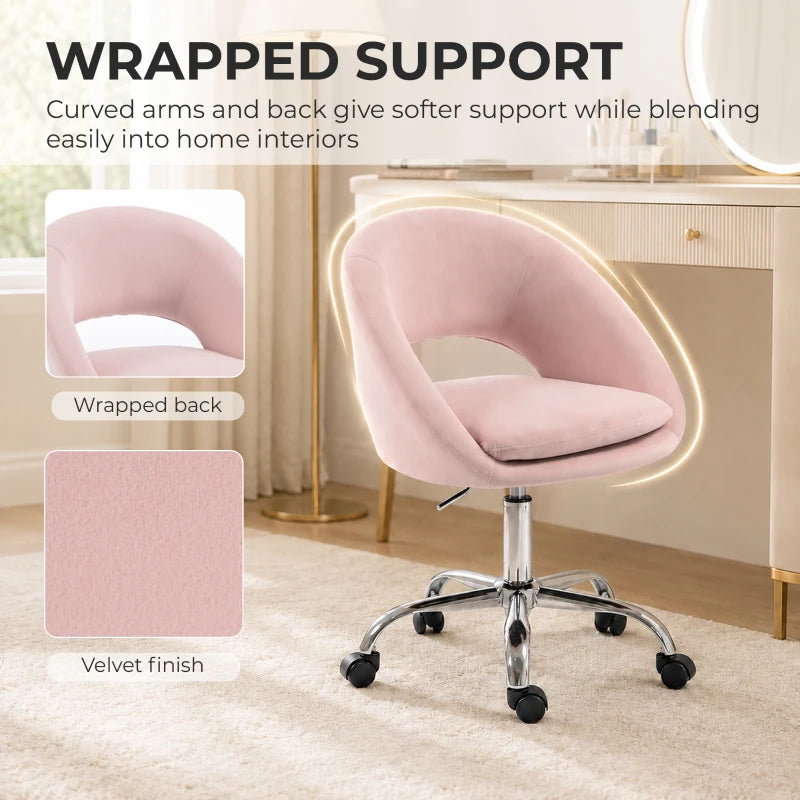 Pink velvet desk chair with wrapped curved arms and supportive back on caster base
