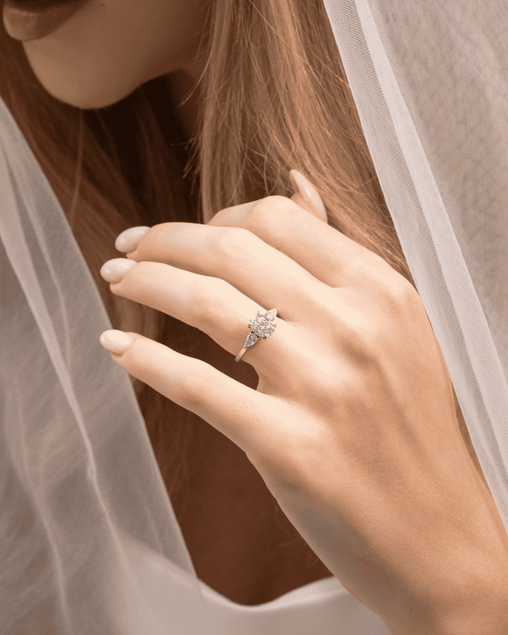 Sterling silver three-stone engagement ring with oval center and side stones