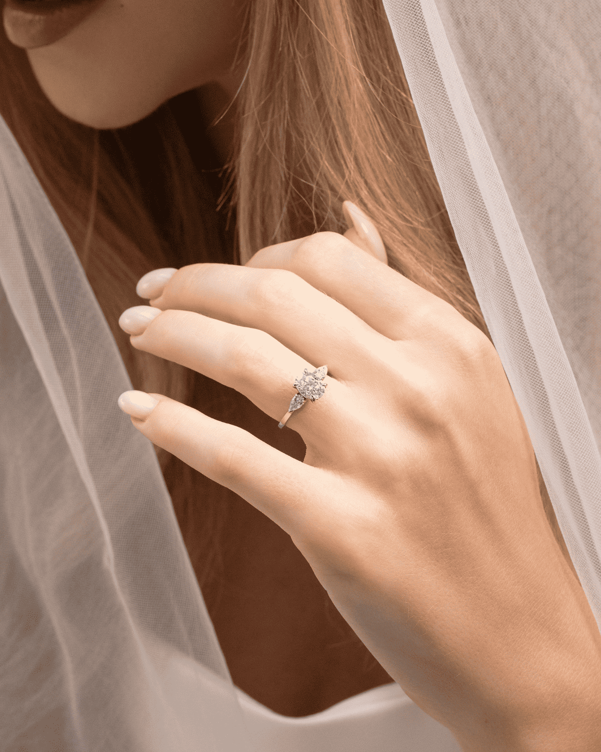 Sterling silver three-stone engagement ring with oval center and side stones