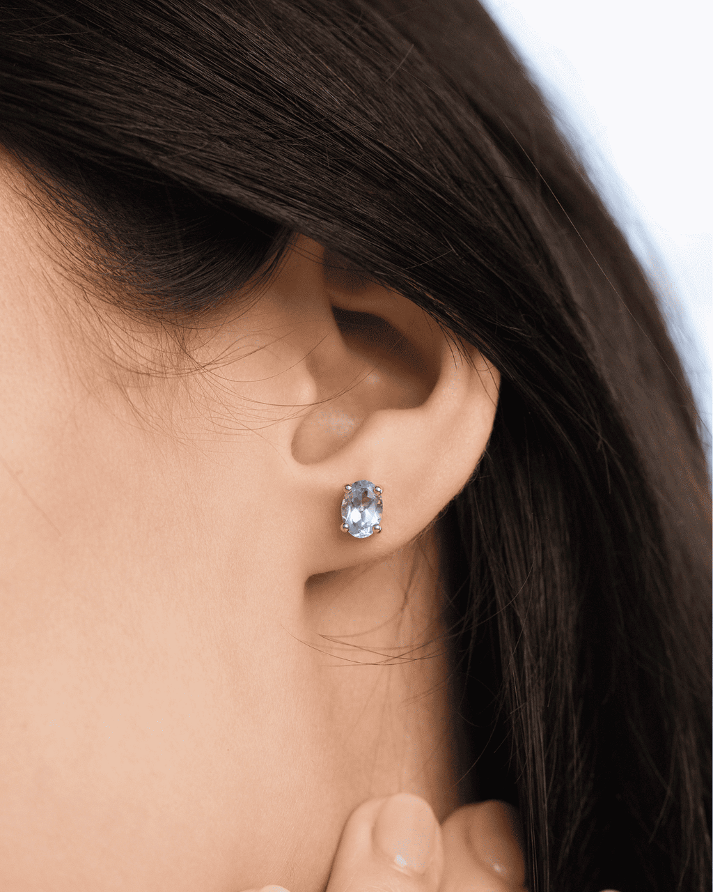 Sterling silver blue topaz stud earring on lobe
