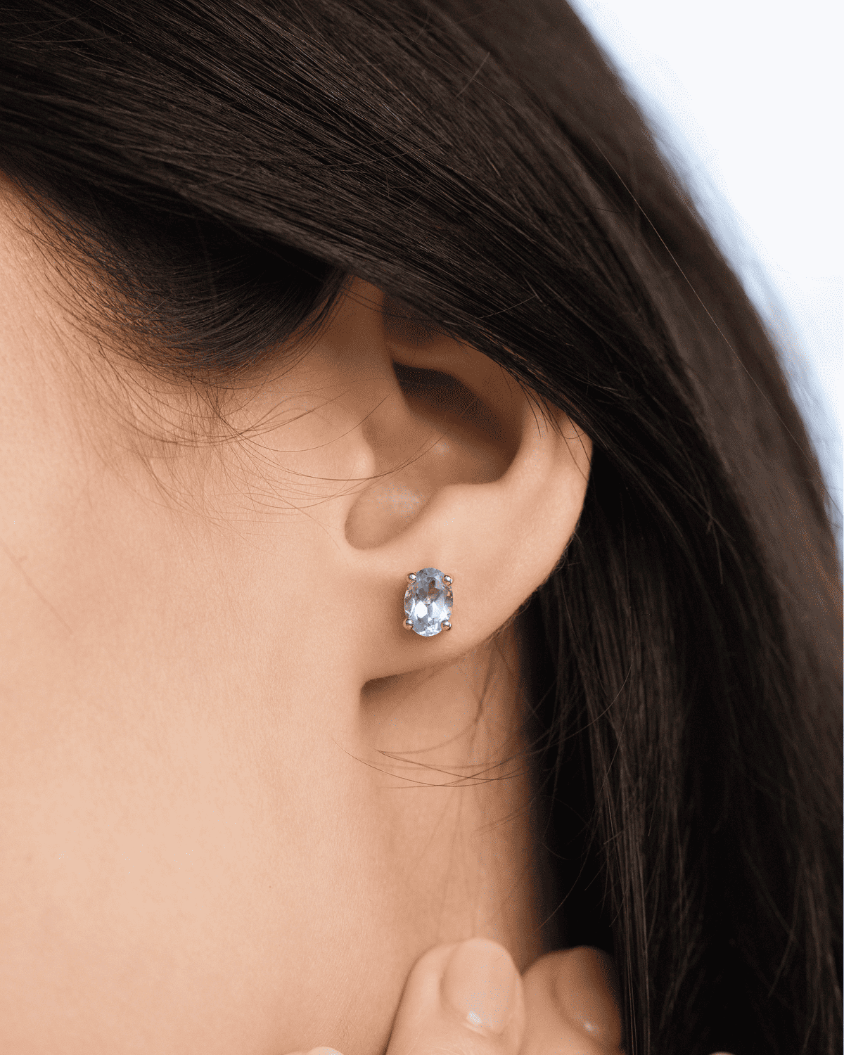 Sterling silver blue topaz stud earring on lobe