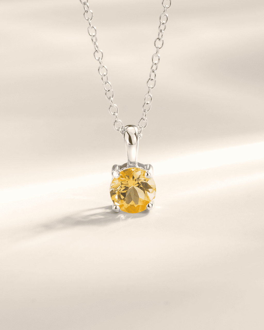 Sterling silver solitaire pendant necklace with round yellow citrine gemstone centerpiece