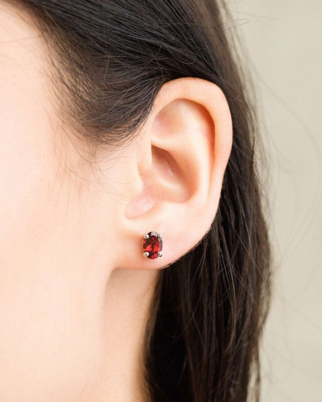Red garnet stud earrings in sterling silver, oval center stone with halo details