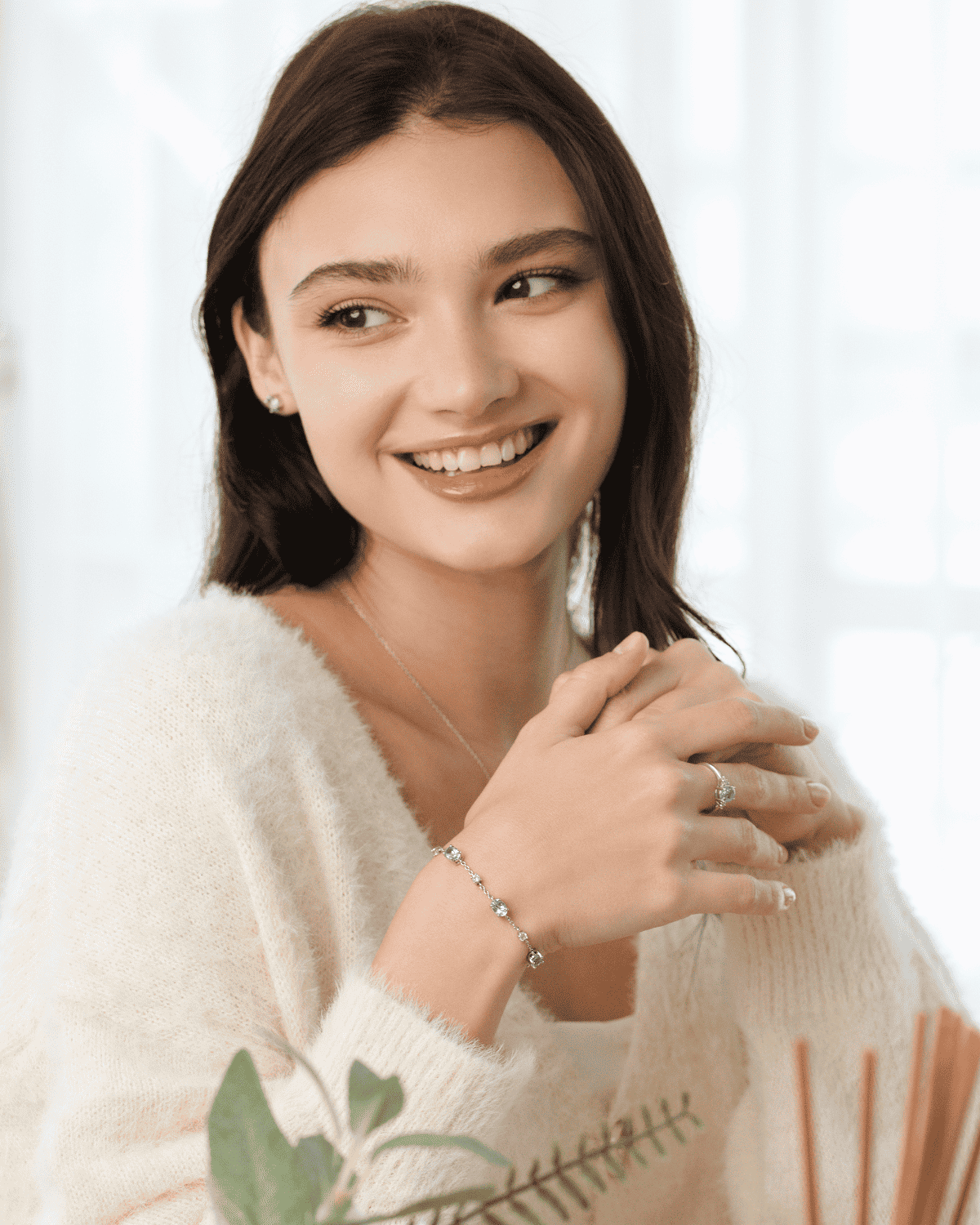 Sterling silver blue topaz necklace, bracelet, and ring worn by smiling model