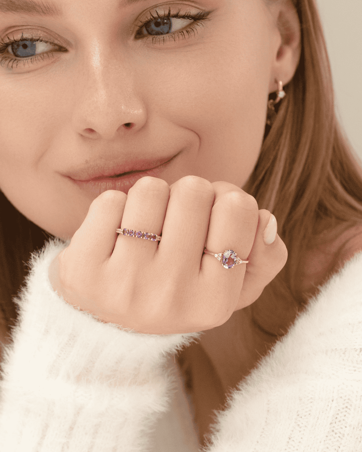 Lavender amethyst ring on hand with slim gold band and side sparkle stones