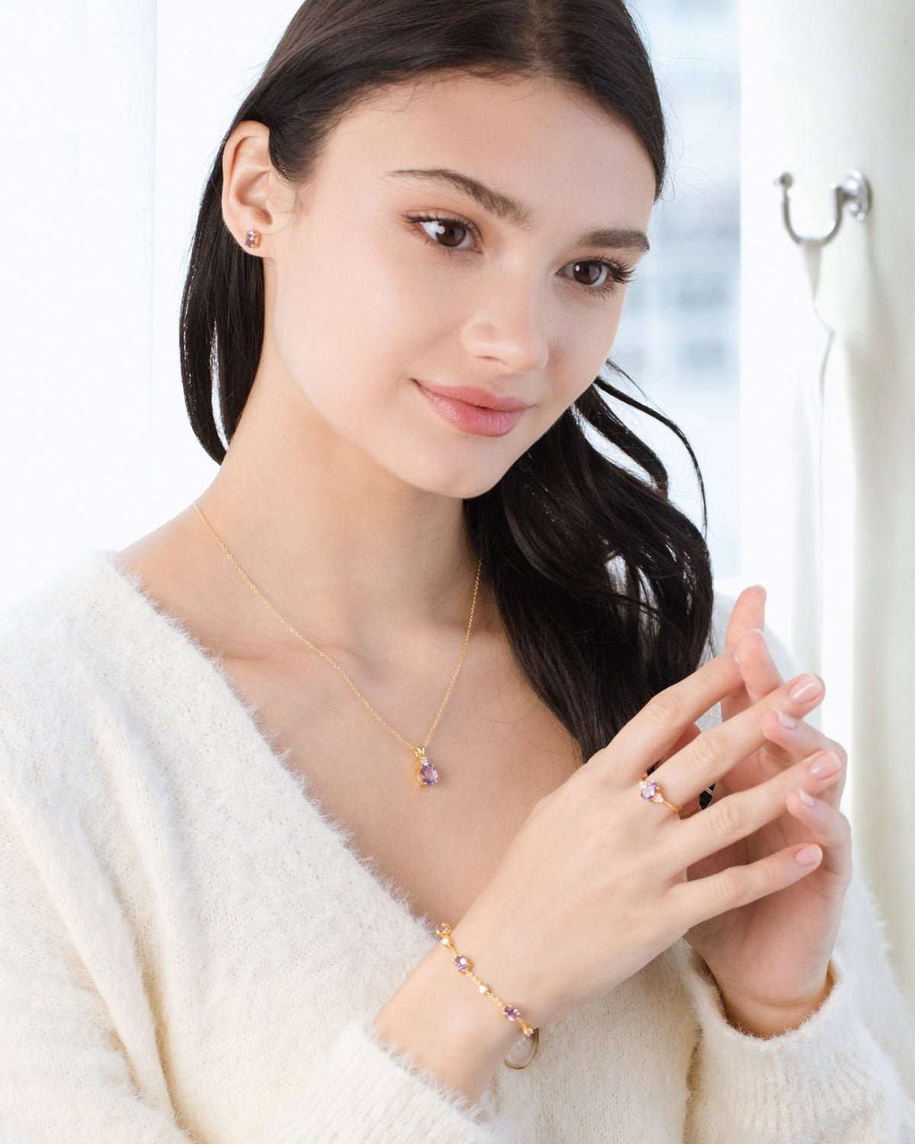 Amethyst pendant necklace with matching studs, ring, and bracelet on model