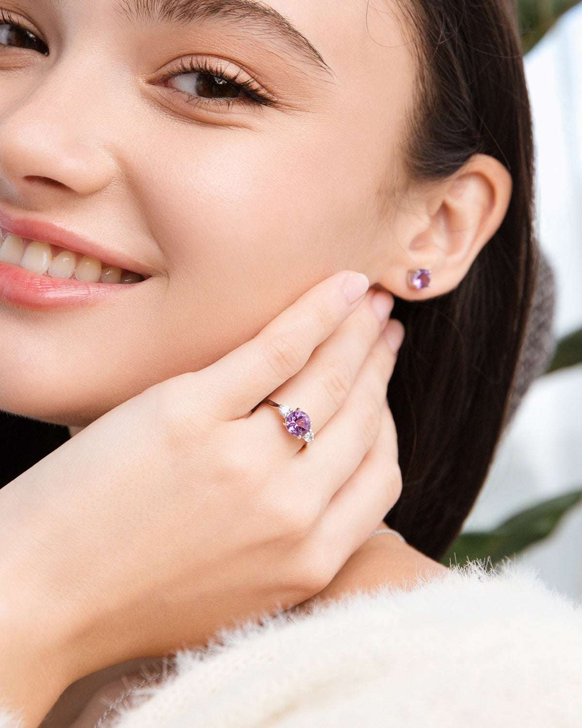 Lavender amethyst three-stone ring on finger with sterling silver band