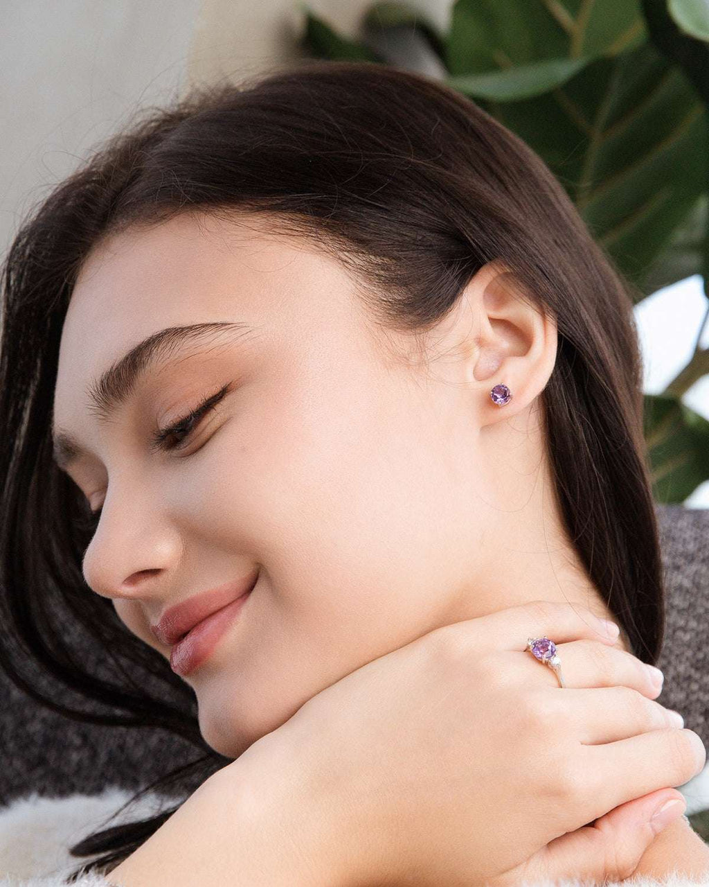 Lavender amethyst ring on finger with purple stones and sterling silver band
