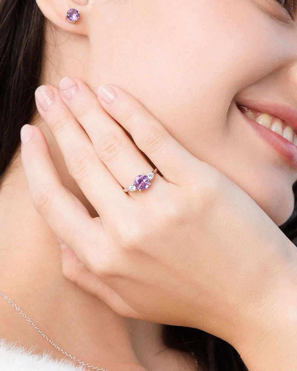 Lavender amethyst three-stone ring on hand with sterling silver band