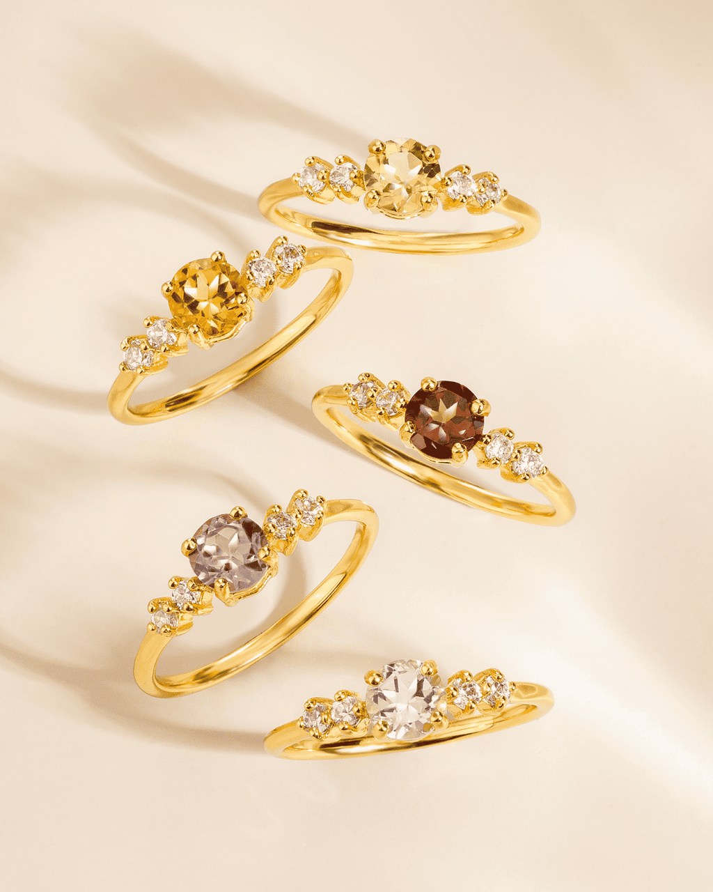 Gold vermeil five-stone ring set with lavender center stones and clear side stones