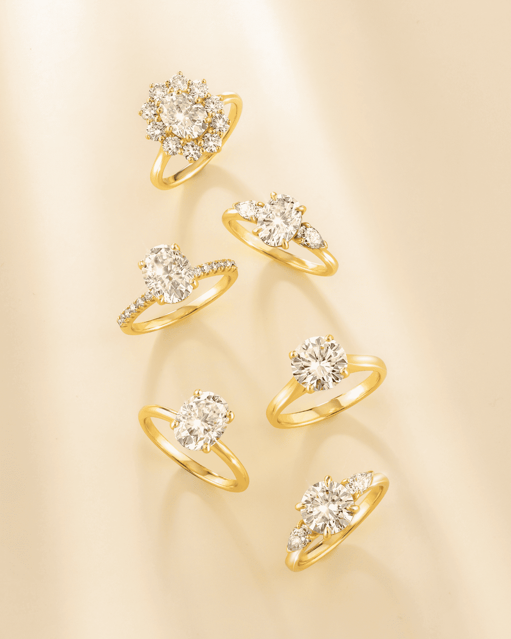 Gold vermeil three-stone engagement ring with round moissanite center and side stones