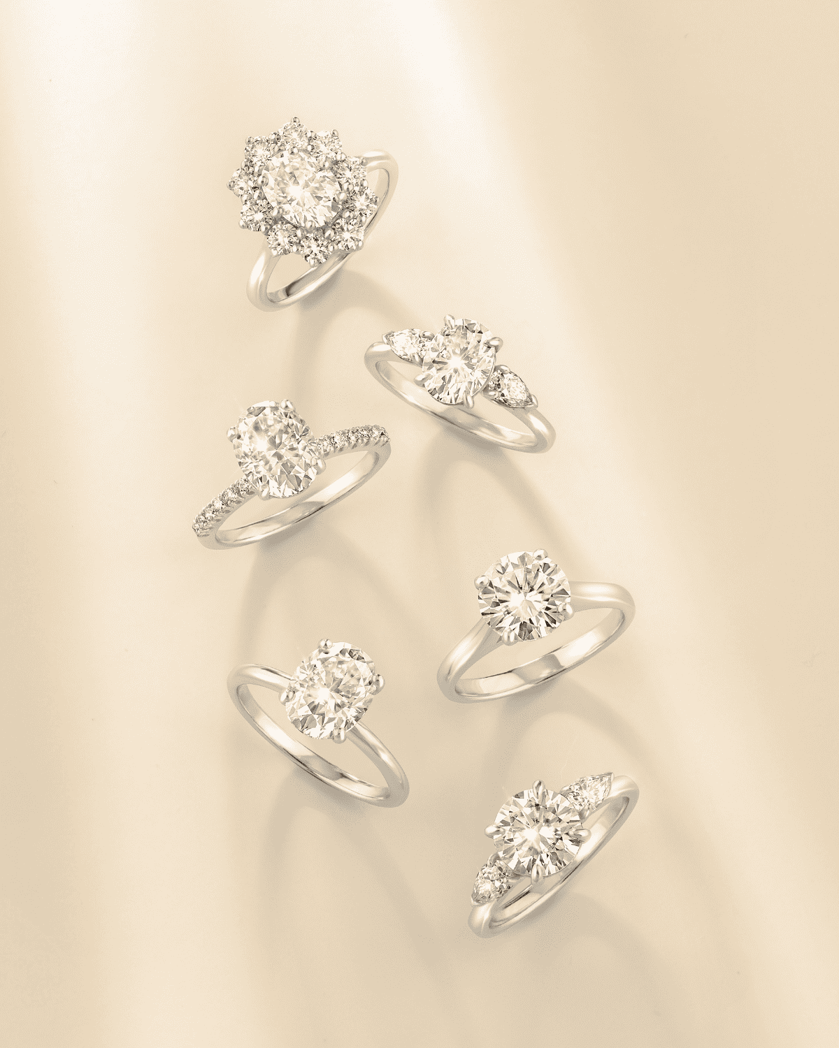 Multiple oval three-stone sterling silver rings with clear stones, front views
