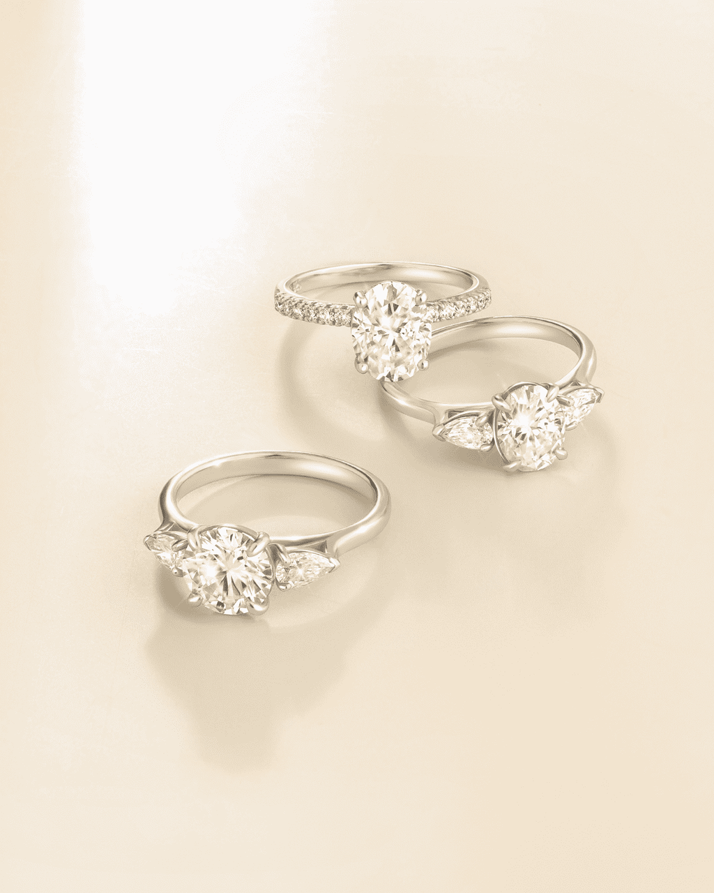 Set of oval three-stone sterling silver rings with clear center stones