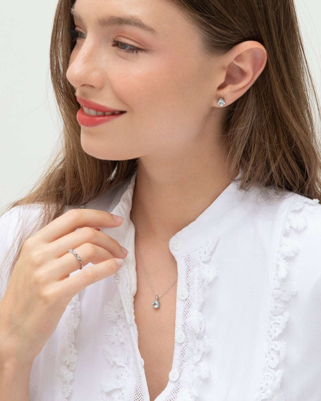 Sterling silver jewelry set with blue gemstone pendant, drop earrings, and ring