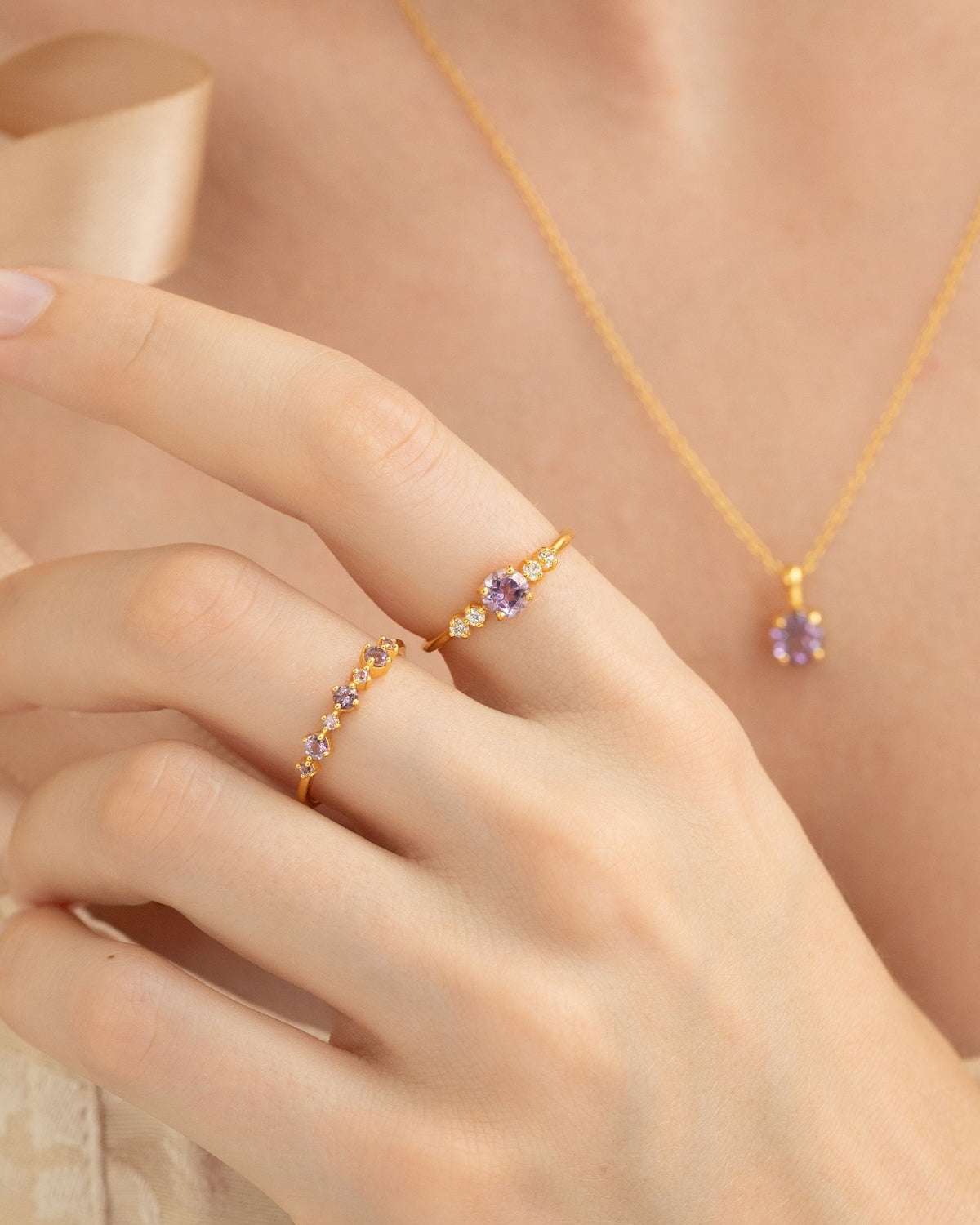 Gold vermeil five-stone amethyst ring with lavender center stone and clear accents