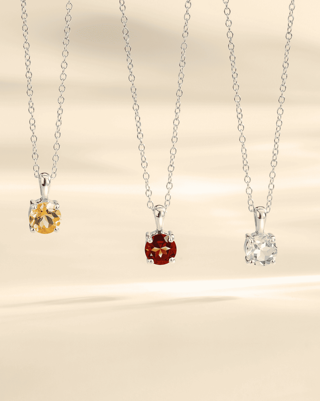 Silver chain solitaire pendant necklaces with red and other colored gemstones