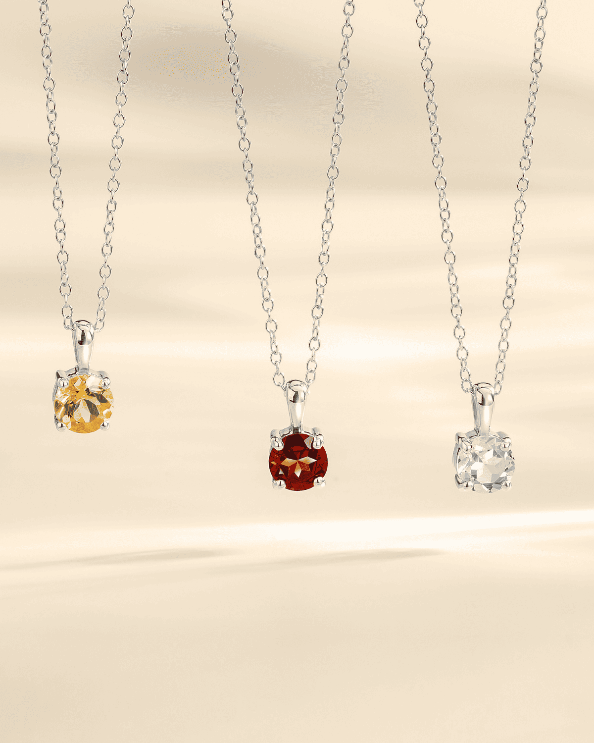 Silver chain solitaire pendant necklaces with red and other colored gemstones