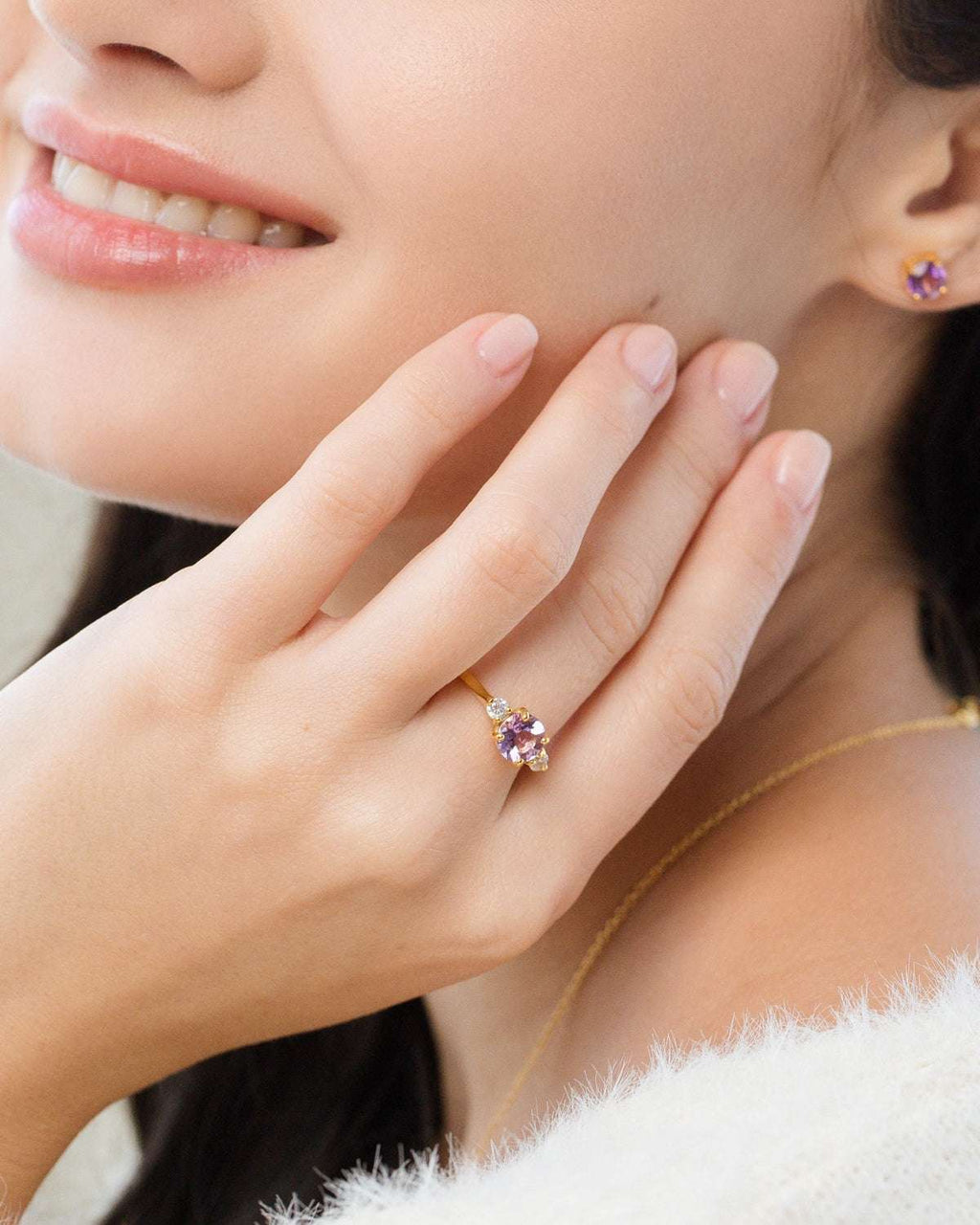 Lavender amethyst three-stone ring with small side stones, gold-tone setting