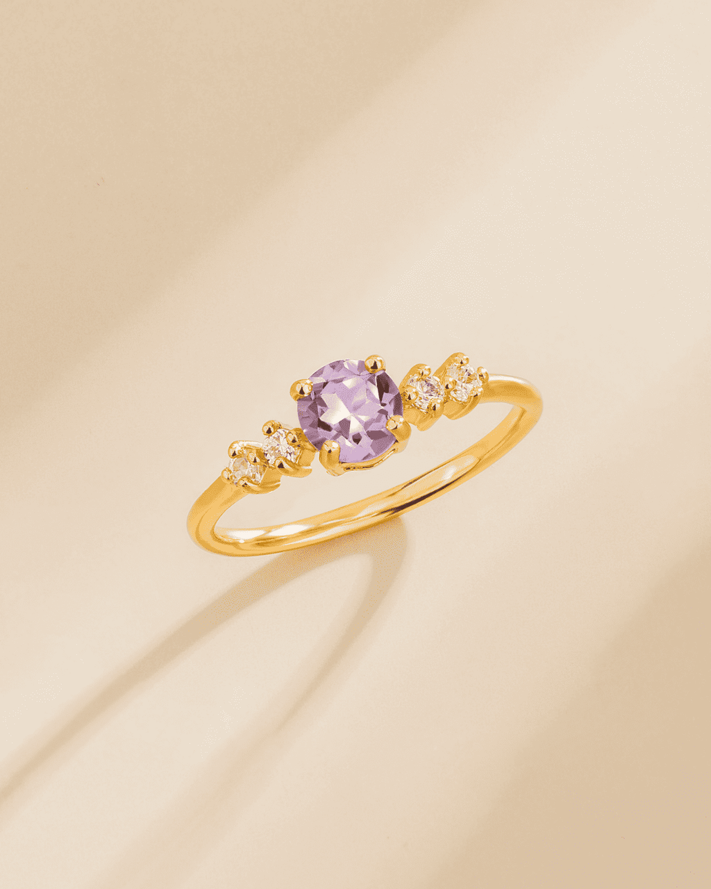 Gold vermeil five-stone ring with lavender oval center stone and clear side stones