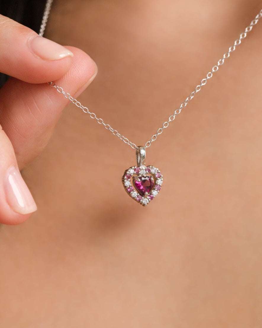 Sterling silver heart-shaped pendant with pink gemstones on fine chain