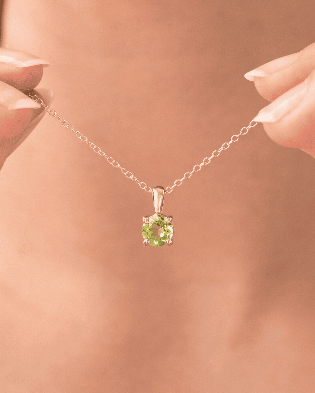Sterling silver chain pendant necklace with small round peridot-green solitaire