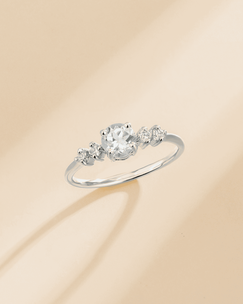 Sterling silver ring with round center stone and smaller side stones