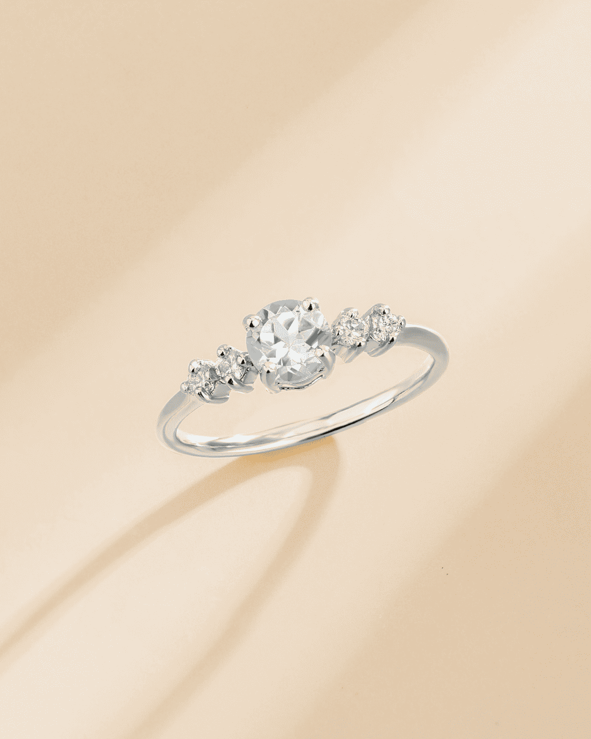 Sterling silver ring with round center stone and smaller side stones