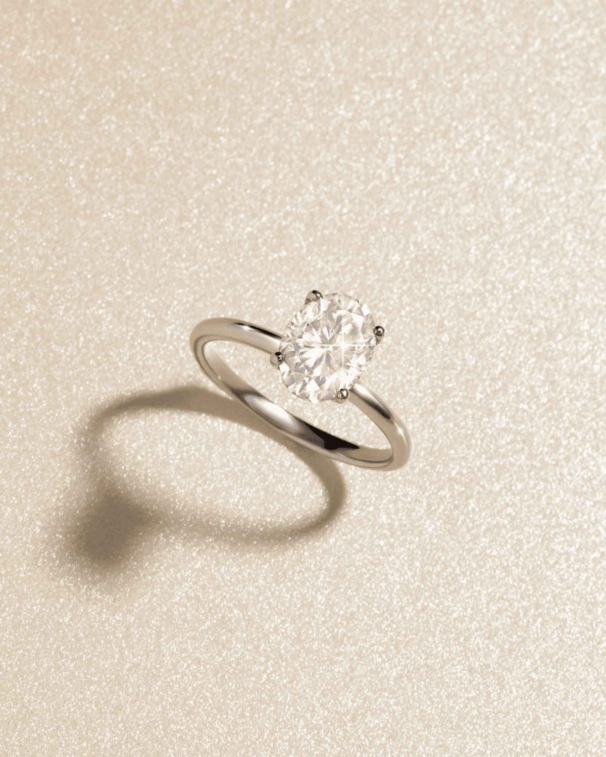 Sterling silver oval solitaire engagement ring in side view, prong-set oval moissanite