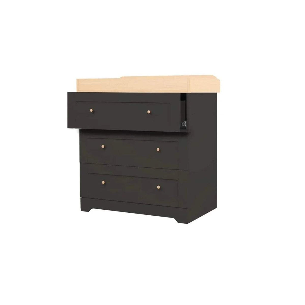 Angled view: slate changing chest with honey oak top, 3 drawers and brass knobs